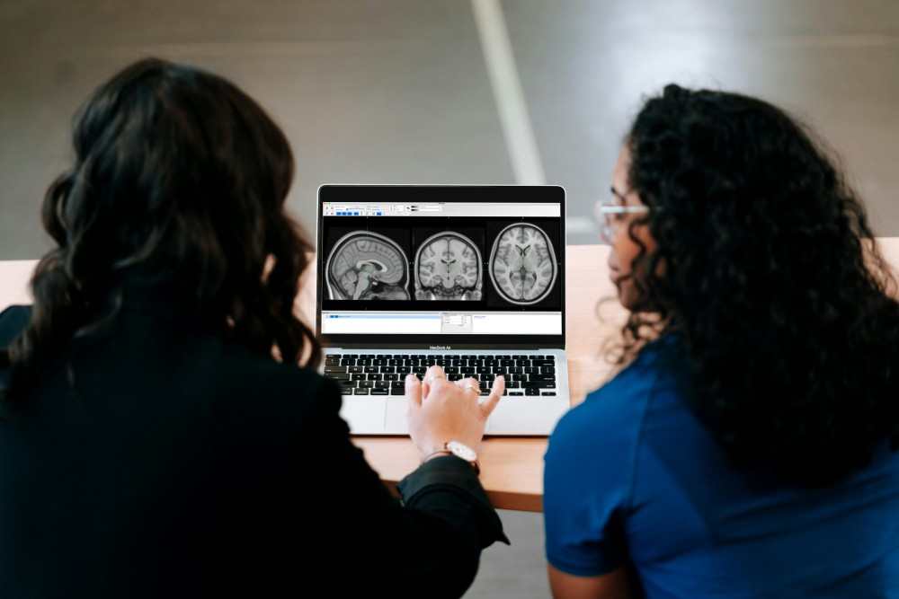 Présentation de deux femmes examinant les résultats d'IRM d'un patient ayant une SEP